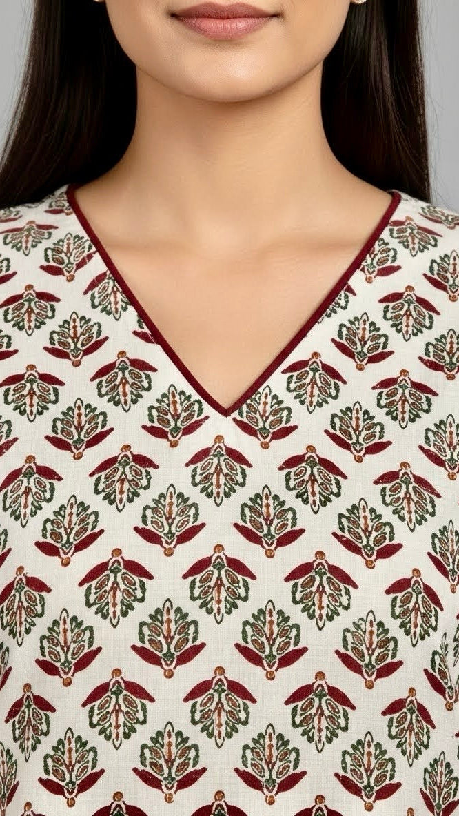 Woman wearing a patterned top with a neutral background