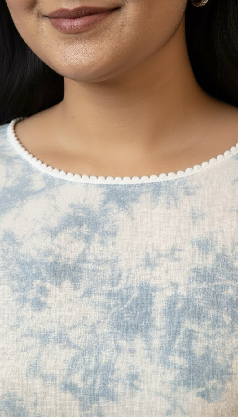 Close-up of a person wearing a tie-dye shirt with a blurred background