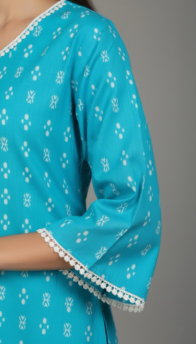 Close-up of a turquoise kurta with white floral patterns and lace details on a gray background