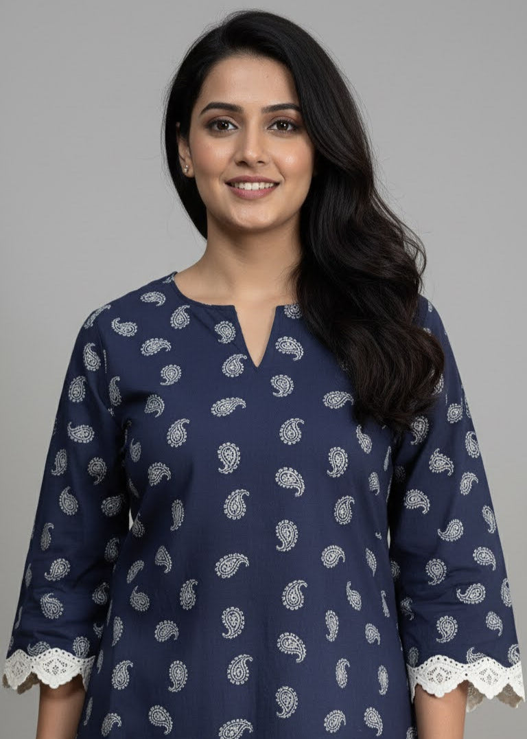 Woman wearing a navy blue kurta with white patterns on a gray background