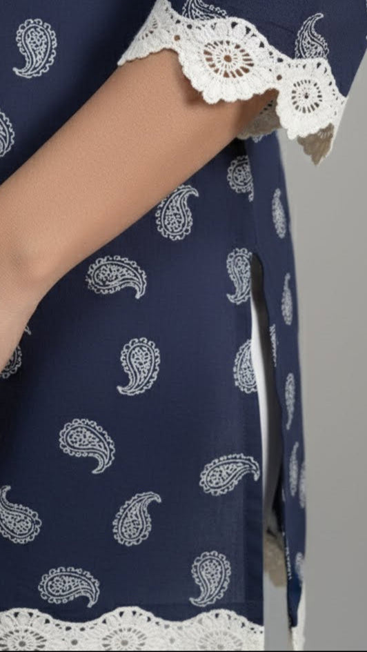 Navy blue dress with white paisley pattern and lace trim on a gray background