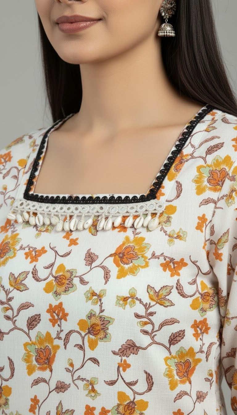 Woman wearing a floral patterned top with intricate details