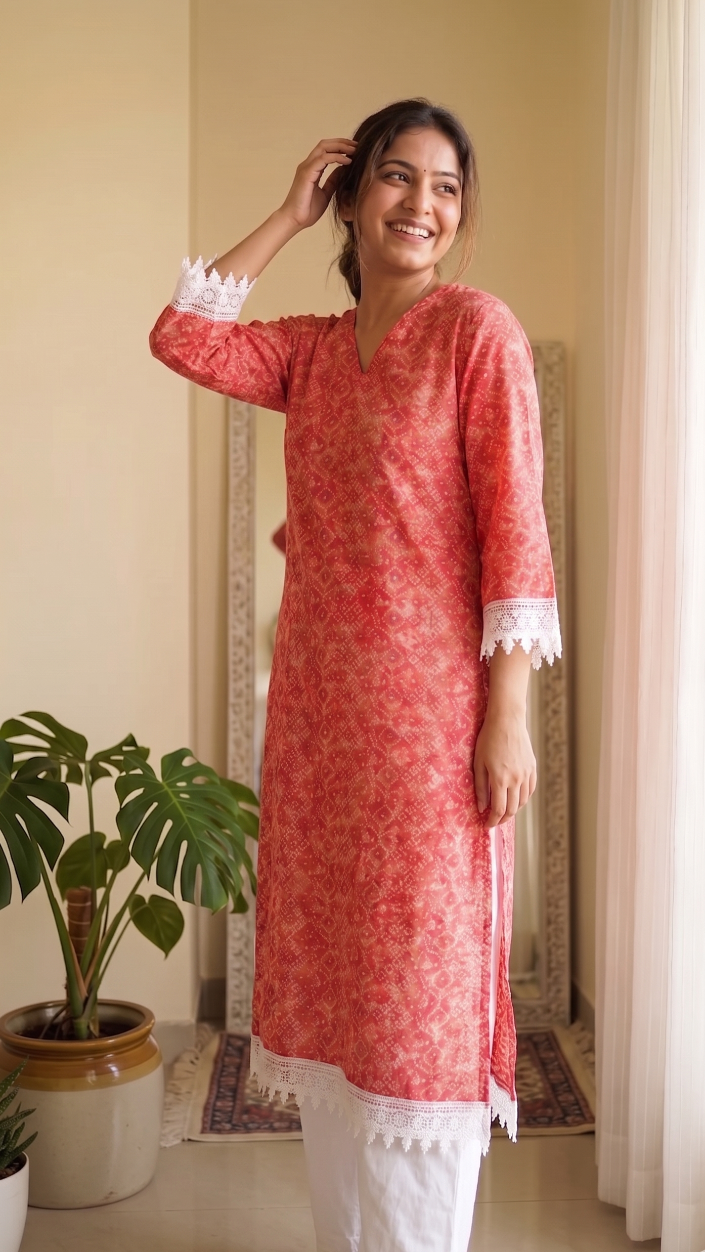 Woman wearing a red kurta with white trim in a home setting