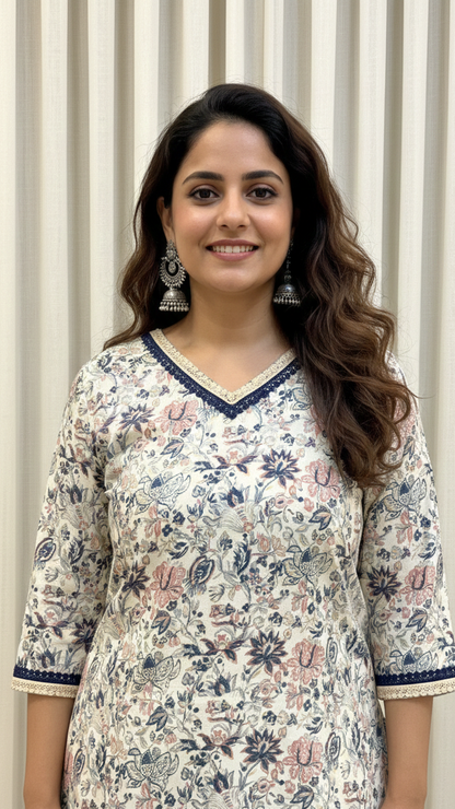 Woman wearing a floral patterned kurta against a neutral background