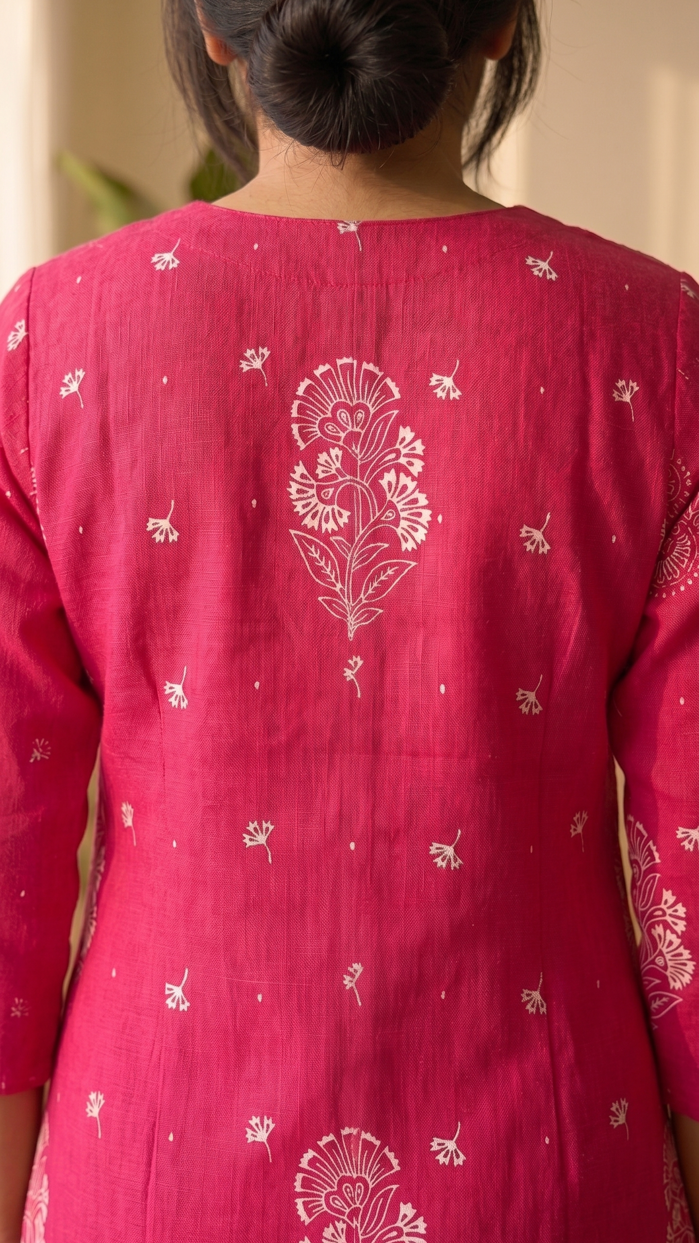 Red traditional outfit with white floral patterns on a plain background