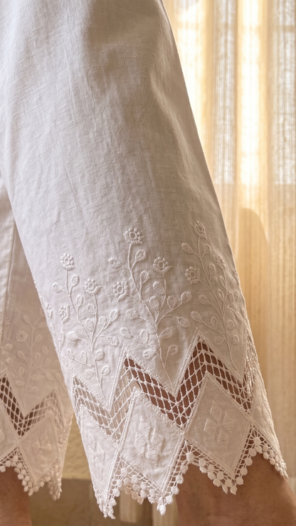 Close-up of white embroidered pants with a blurred background