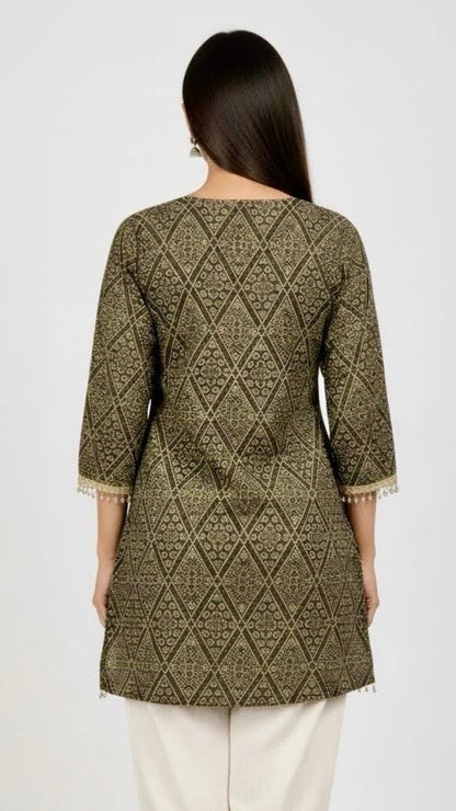Woman wearing a patterned green kurta with white pants on a white background