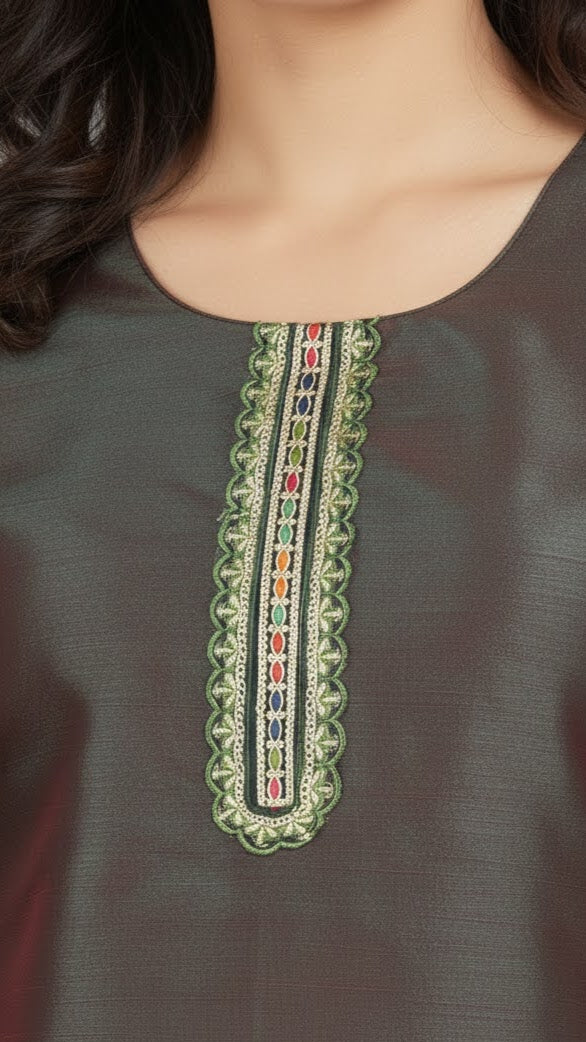 Close-up of a dark green garment with intricate embroidery on the neckline.