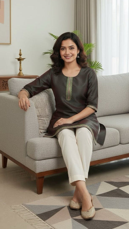 Woman sitting on a gray sofa in a living room